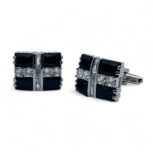 Pair of black square cufflinks with silver accents on a white background
