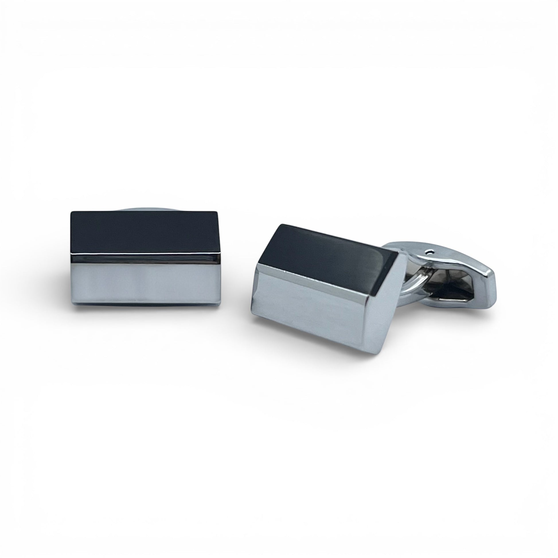 Pair of rectangular cufflinks with black and silver finish on a white background